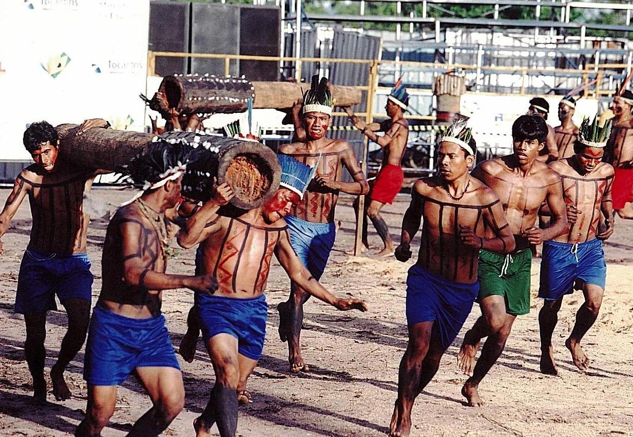 Índios em corrida com tora