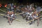 índios em ritual com pedaços de madeira